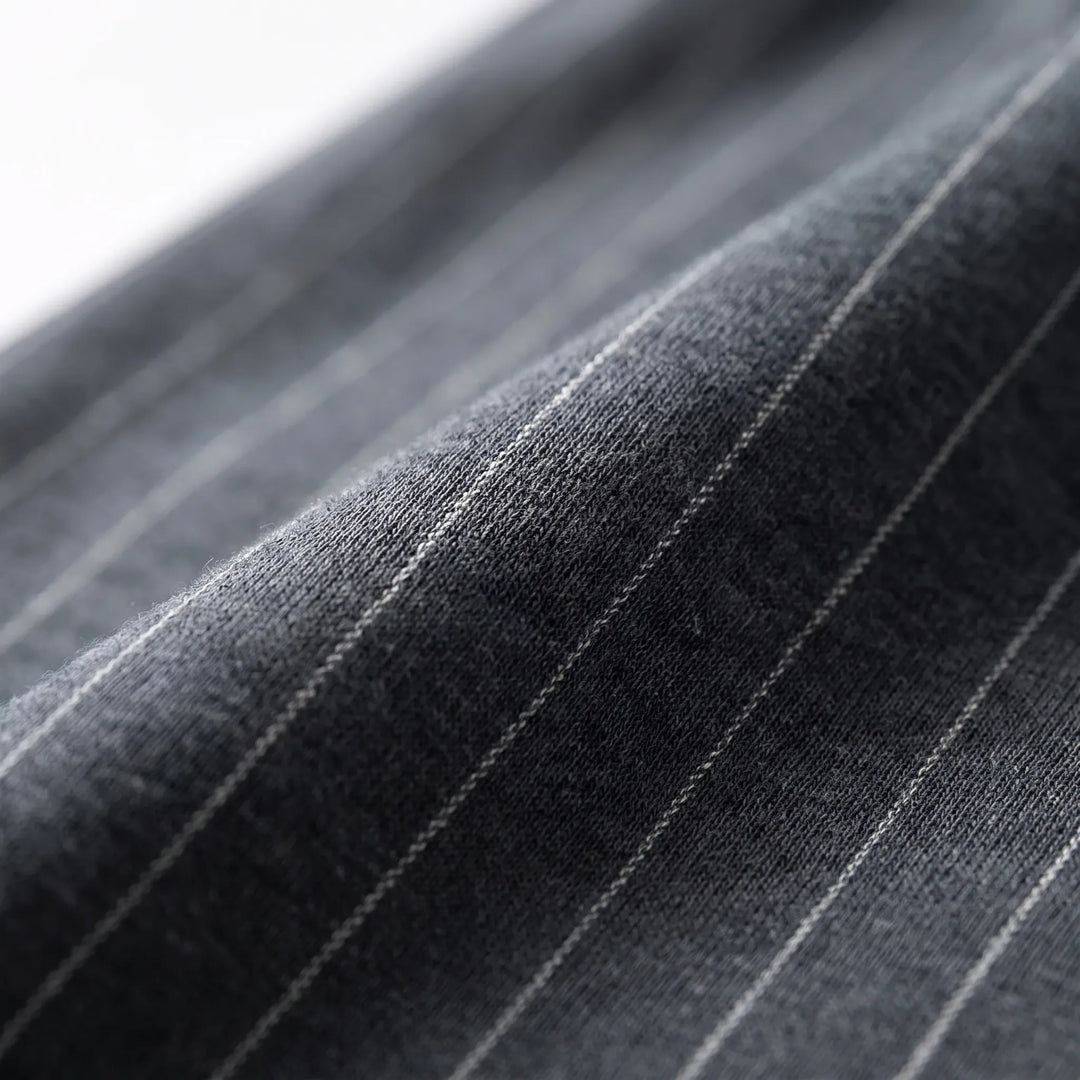 Close-up of the dark gray knit fabric with thin light pinstripes, showing the soft texture of the weave. 5