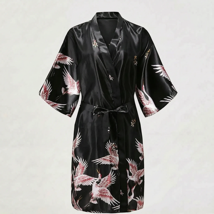 Black satin version of the short kimono robe laid flat, with pink and white cranes on the sleeves and skirt. 12