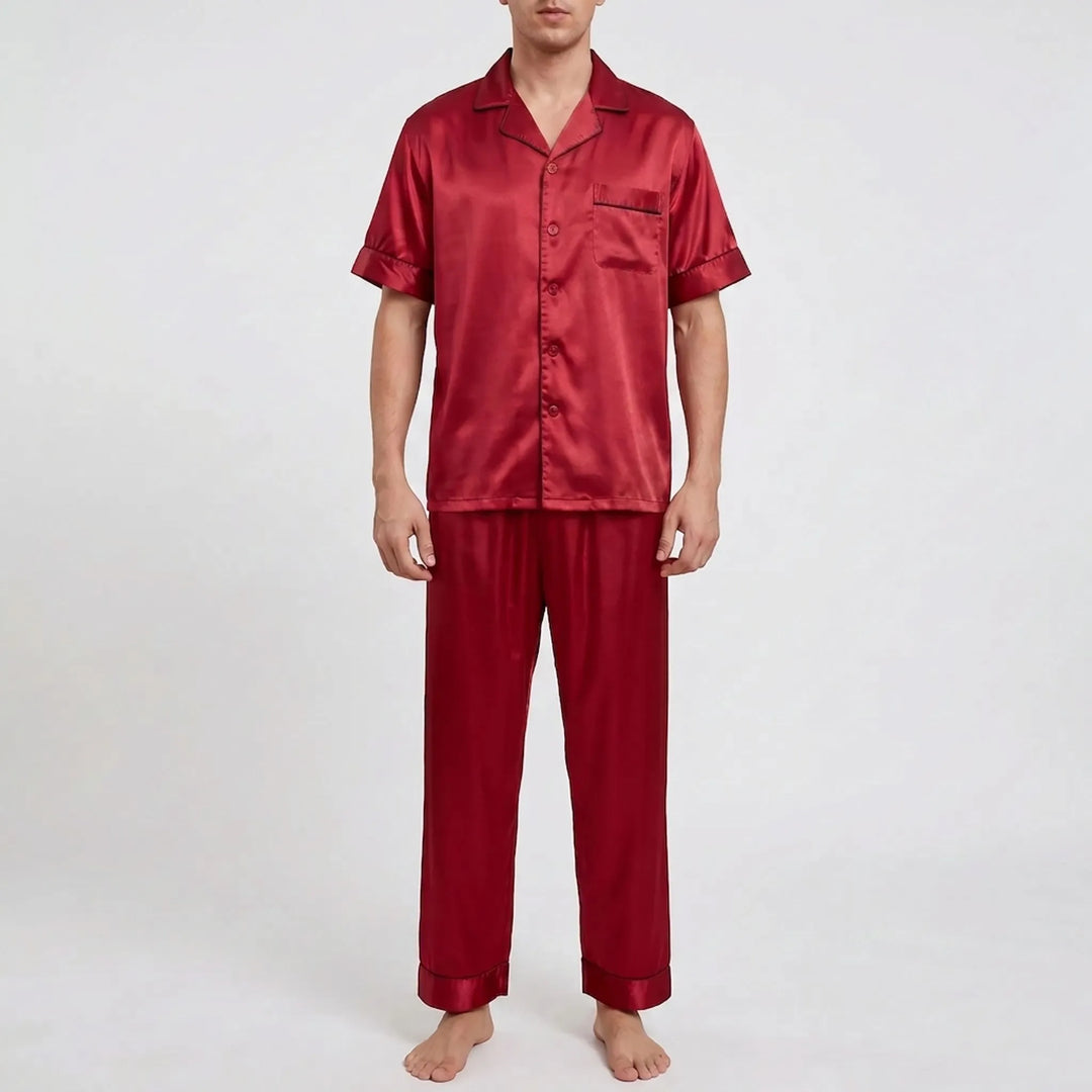 Model wearing the pajama set in glossy burgundy red satin-look fabric with matching tonal piping and a chest pocket. 8