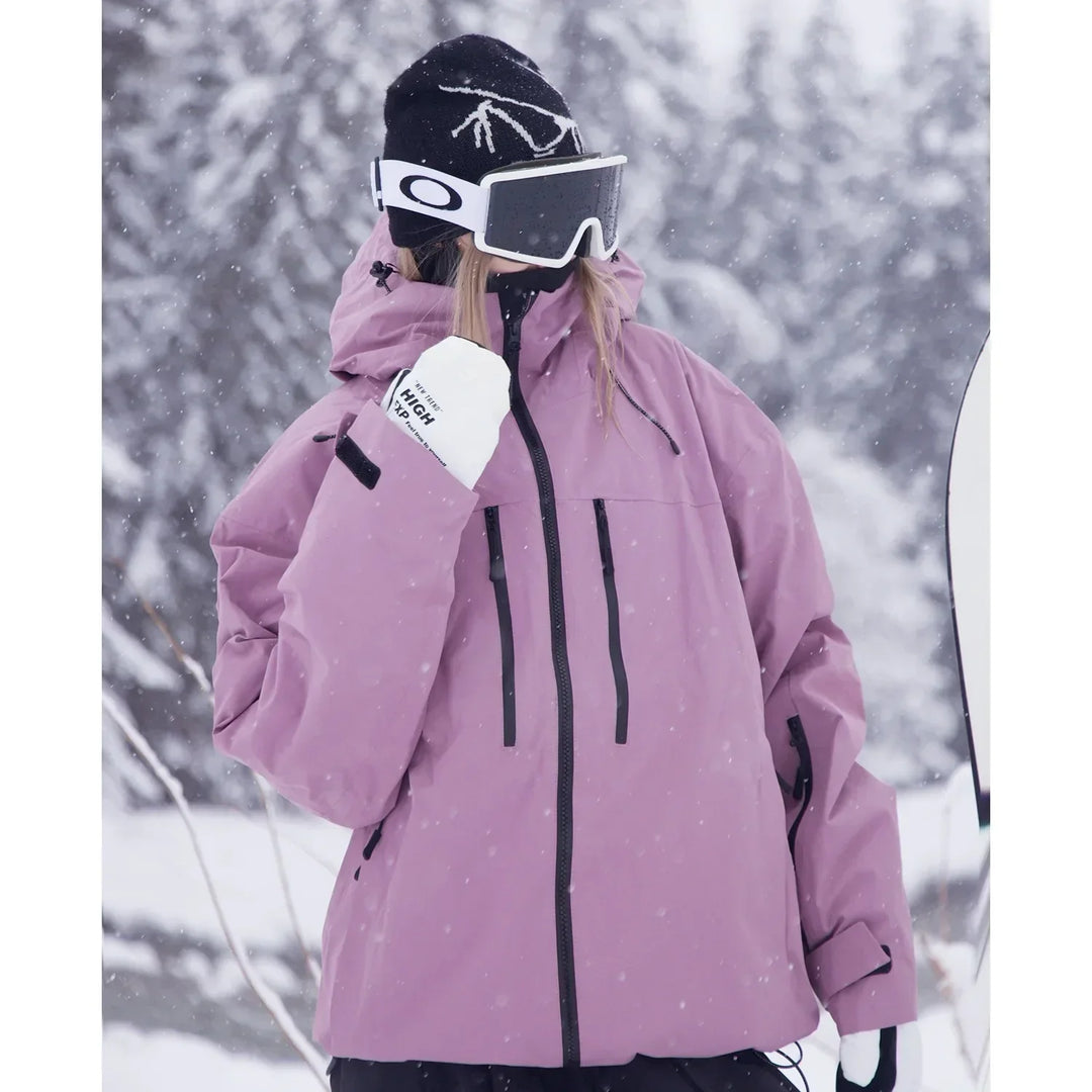 Close three-quarter view of the dusty pink jacket showing the zippered chest pockets and sleeve cuff strap.