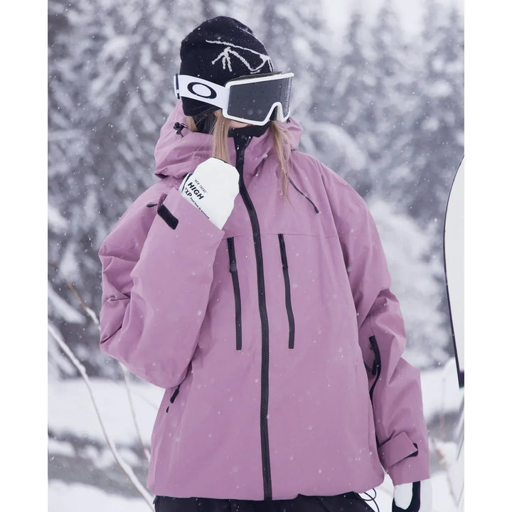 Close three-quarter view of the dusty pink jacket showing the zippered chest pockets and sleeve cuff strap.