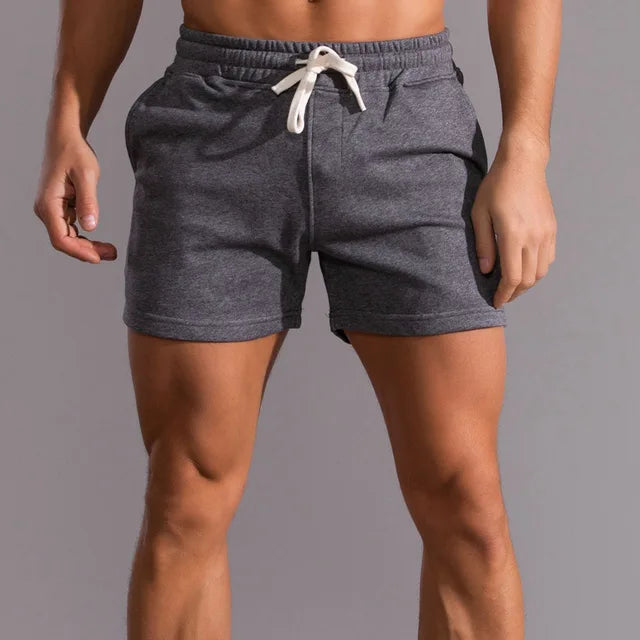Dark gray men's athletic shorts with an elastic waistband and white drawstring.