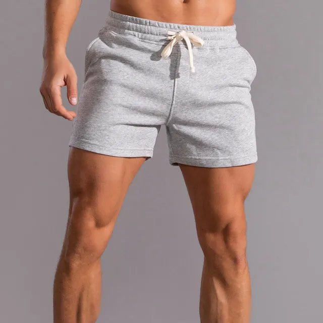 Light heather gray men's athletic shorts with an elastic waistband and cream drawstring.