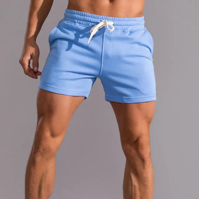 Light blue men's athletic shorts with an elastic waistband and white drawstring.
