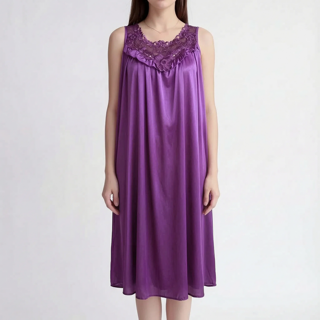 Deep purple version worn by a model facing front, showing the lace yoke, ruffled V trim and relaxed satin silhouette. 11