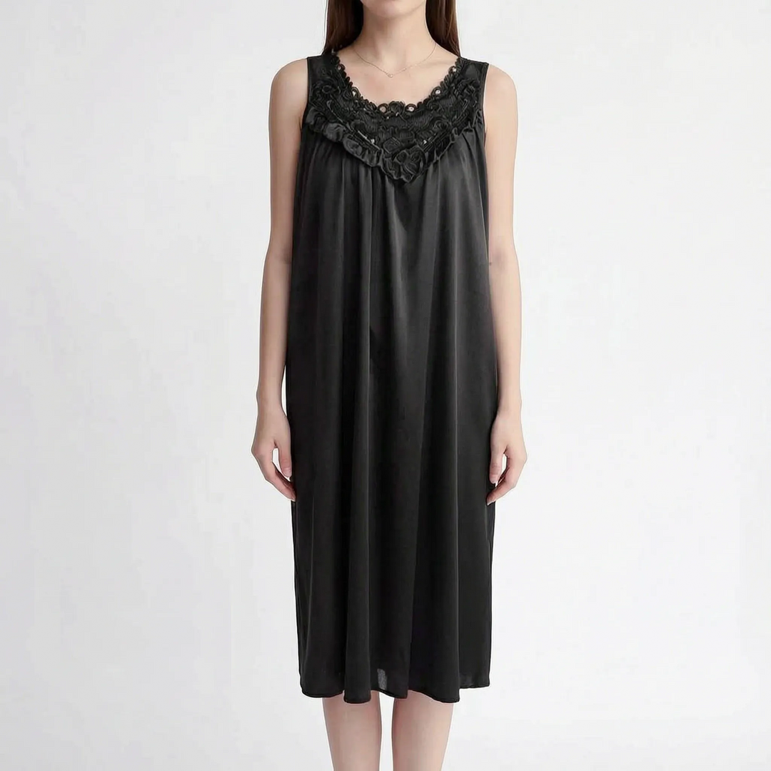 Black version of the sleeveless nightgown on a model, with dark floral lace neckline, ruffle trim and loose satin fit. 12