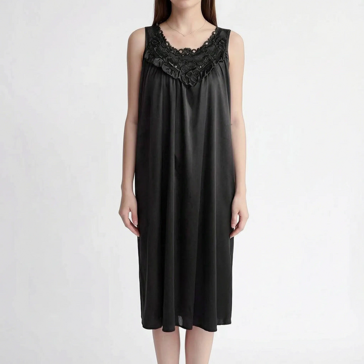 Black version of the sleeveless nightgown on a model, with dark floral lace neckline, ruffle trim and loose satin fit. 12