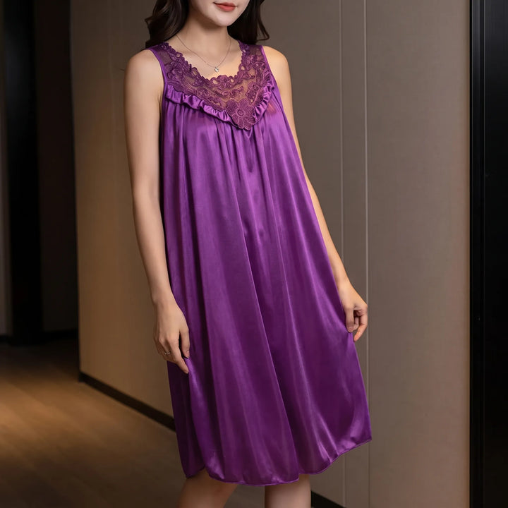 Model wearing the purple satin nightgown with floral lace yoke and ruffle, posed against a warm wood-paneled wall. 1