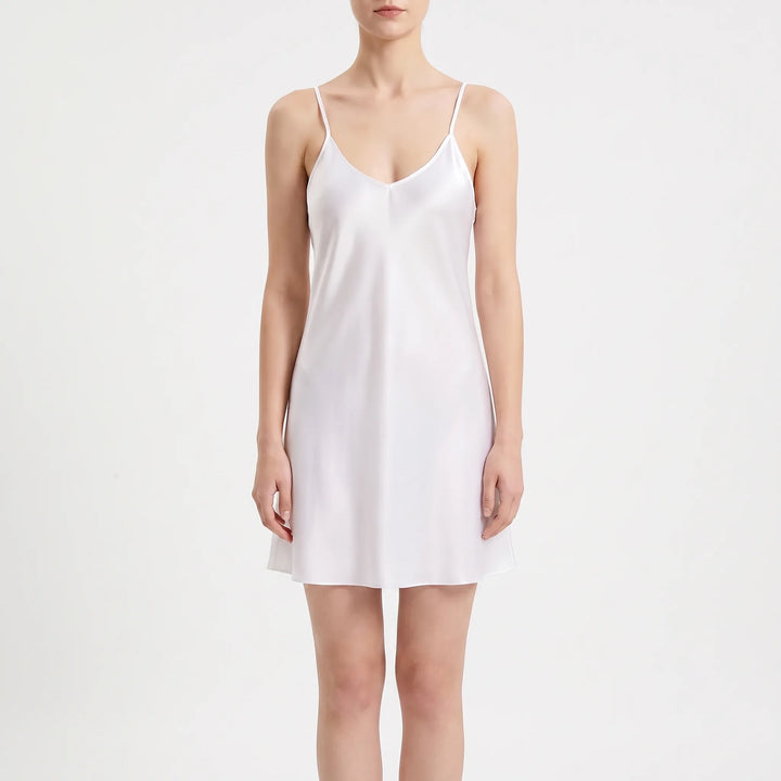 Front view of a model in a white satin V-neck slip nightdress with thin straps, against a plain light background. 2