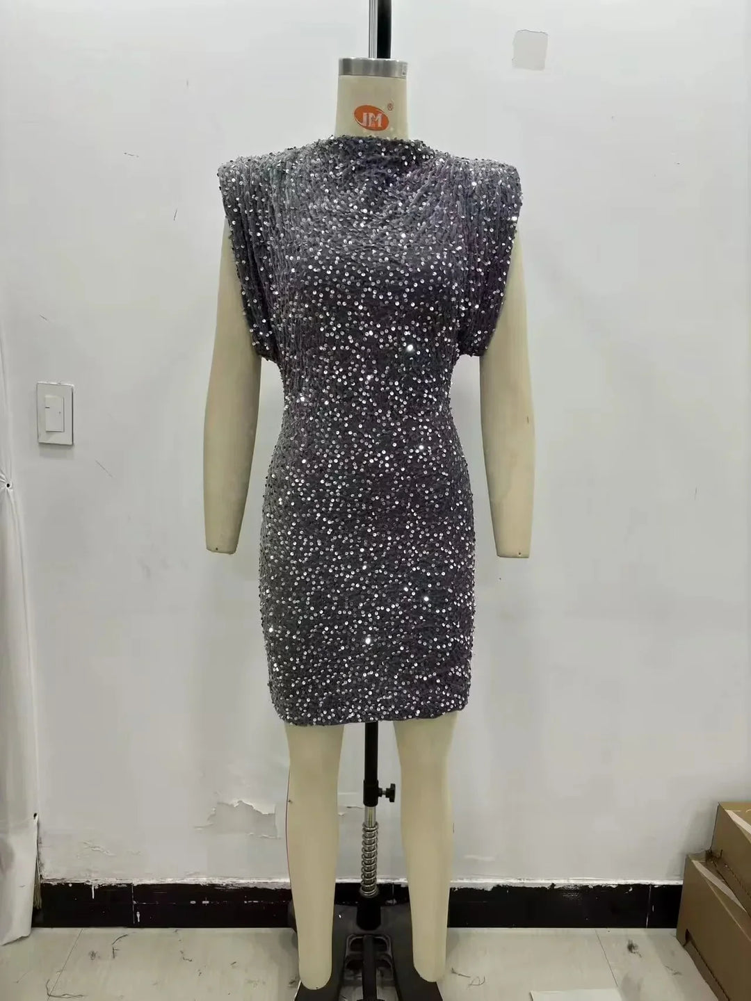 Gray sequined mini dress with padded shoulders displayed on a mannequin, front view 4