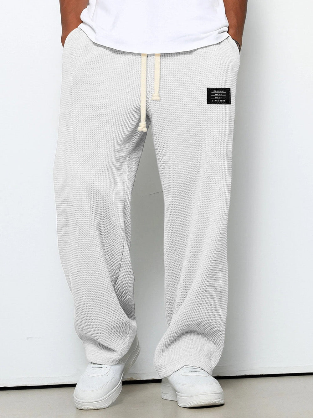 Front view on a model of the wide leg waffle knit pants in off-white 2