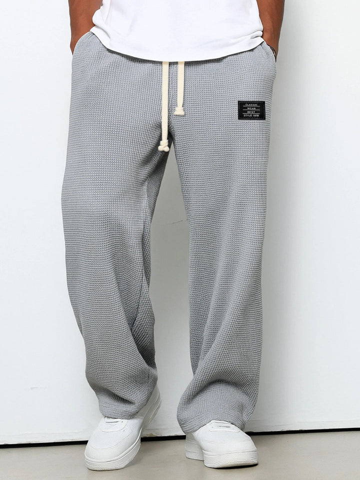 Front view on a model of the wide leg waffle knit pants in light gray 3