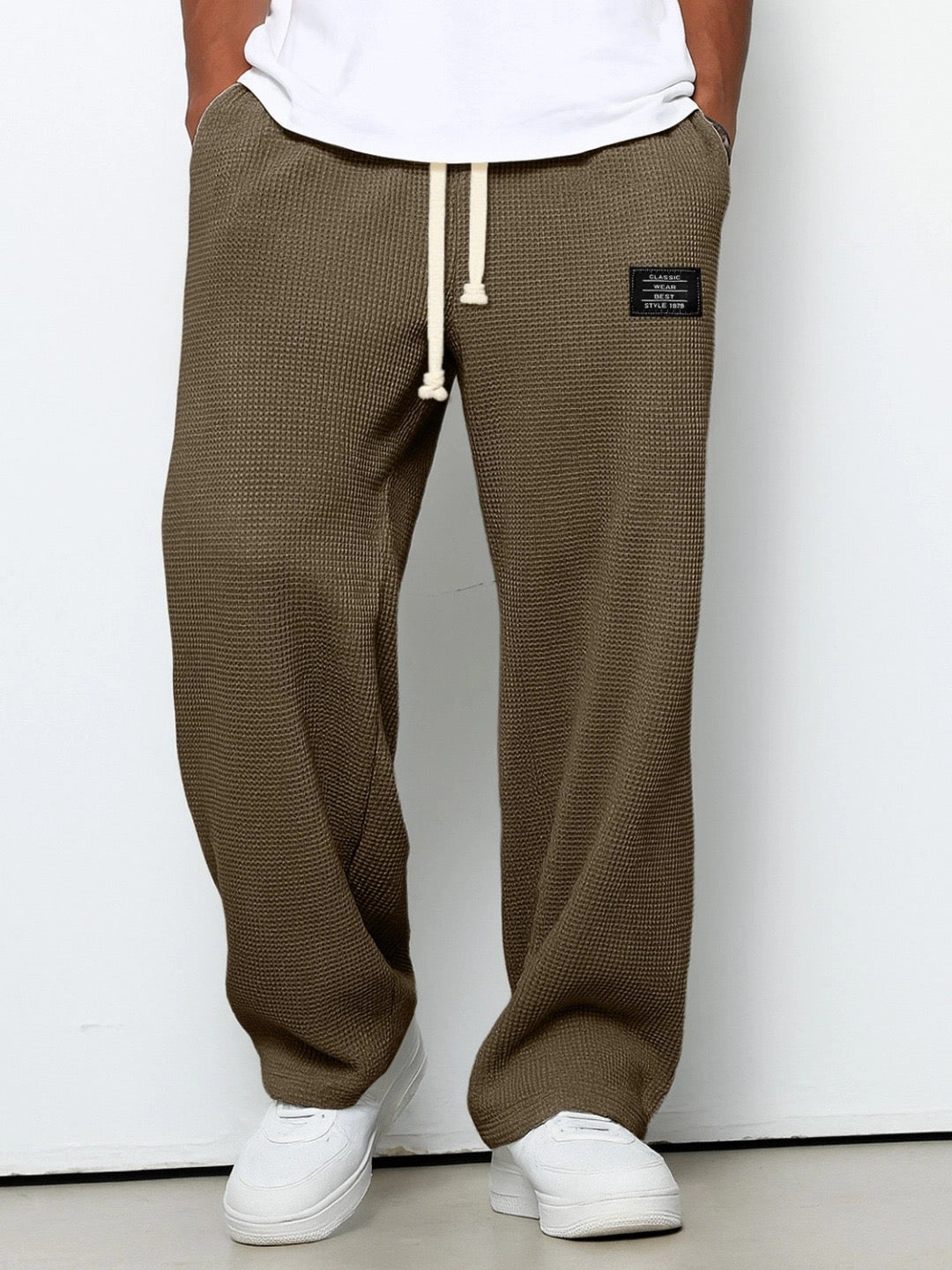 Front view on a model of the wide leg waffle knit pants in brown 5