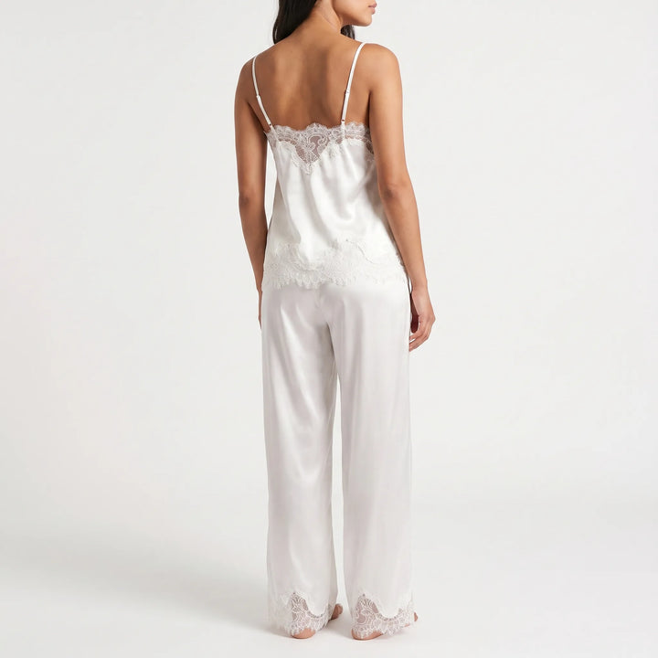 Back view of the white satin set, showing the thin adjustable straps and lace edging along the cami's back and pant hems. 3