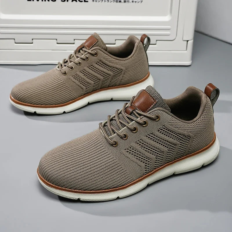 Taupe lace-up sneakers with white soles and brown heel pull tabs.