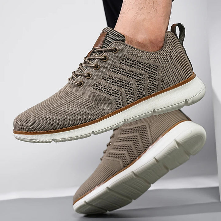 Taupe sneaker worn by a model showing the white tread sole.