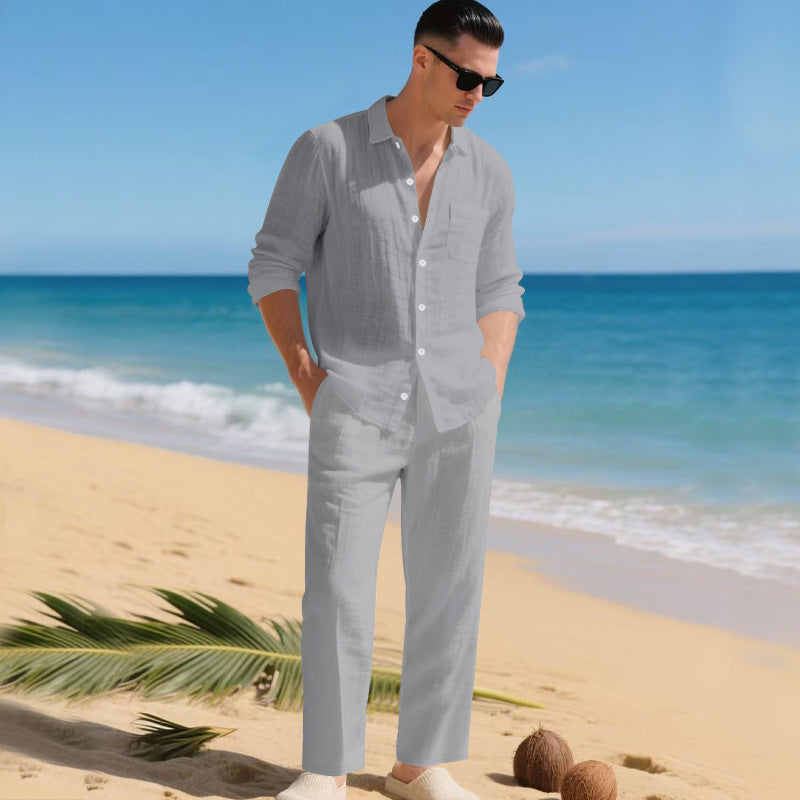 Men's linen shirt and pants set in light gray on a man at the beach, another view.