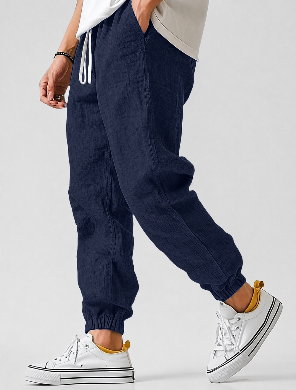 Navy blue textured drawstring joggers with elastic ankle cuffs, another view.