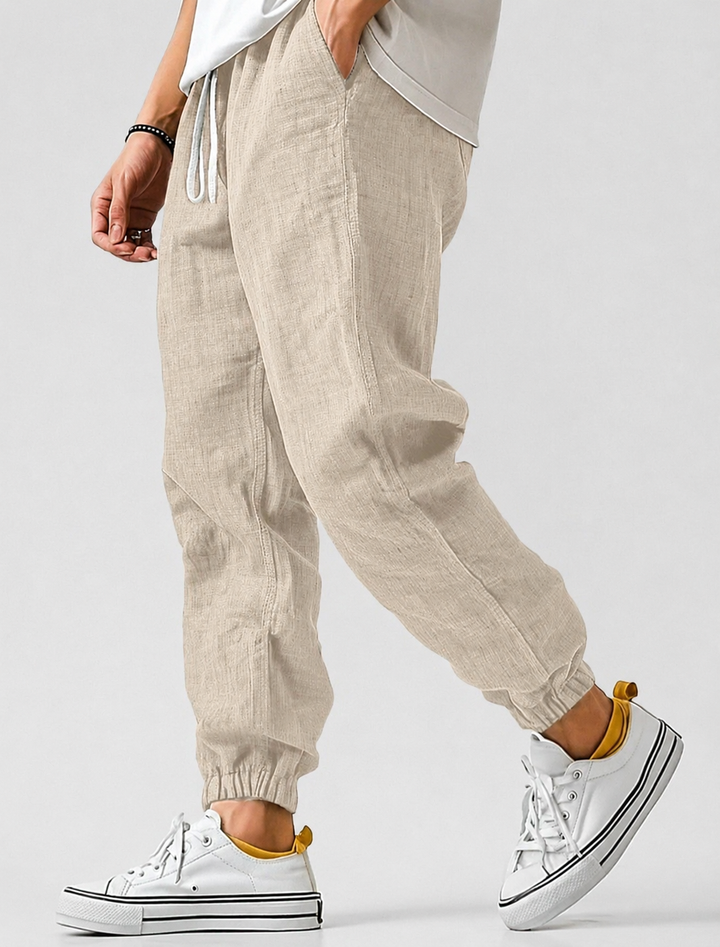 Beige textured drawstring joggers with elastic ankle cuffs, another view.