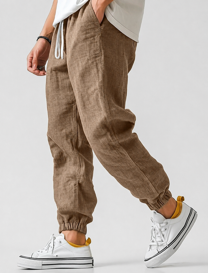 Brown textured drawstring joggers with side pockets and elastic cuffs, another view.