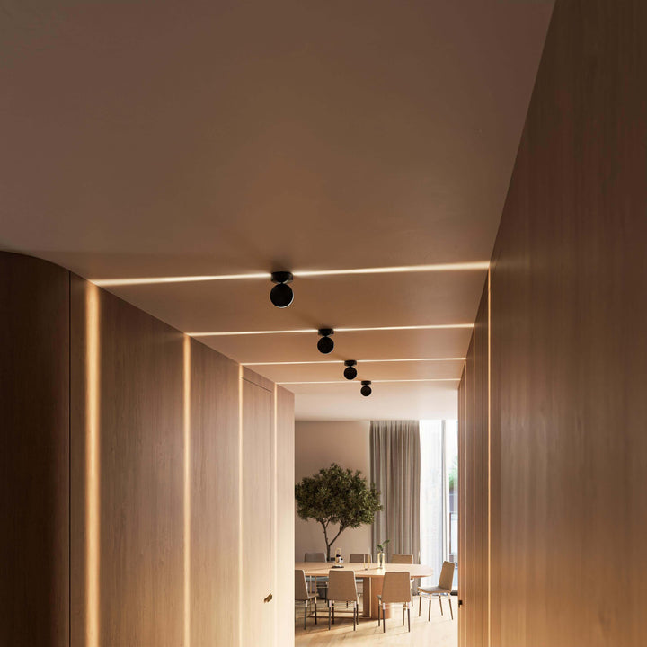 Black LED wall sconce another view showing soft beams crossing the ceiling and walls.