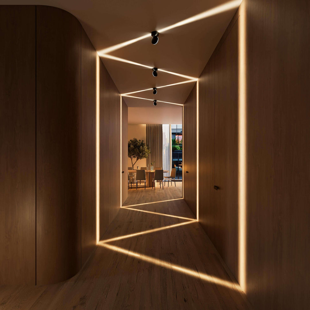 Black LED wall sconce another view showing spotlights projecting warm zigzag beams in a wood-paneled hallway.