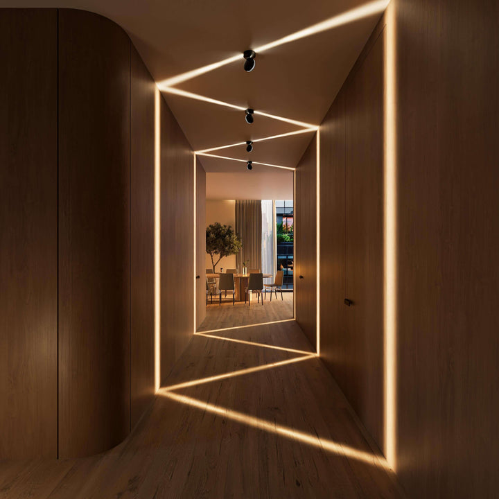 Black LED wall sconce another view showing spotlights projecting warm zigzag beams in a wood-paneled hallway.