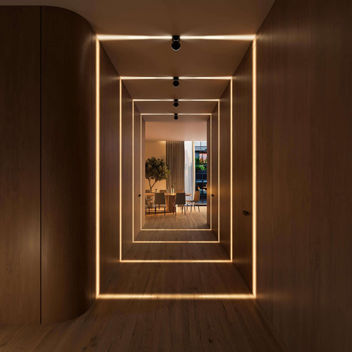 Black LED wall sconce another view showing glowing rectangular frames of light toward the dining room.