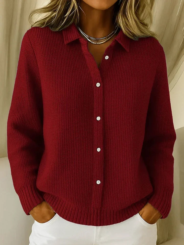 Deep burgundy red textured knit polo sweater with white buttons and ribbed cuffs.