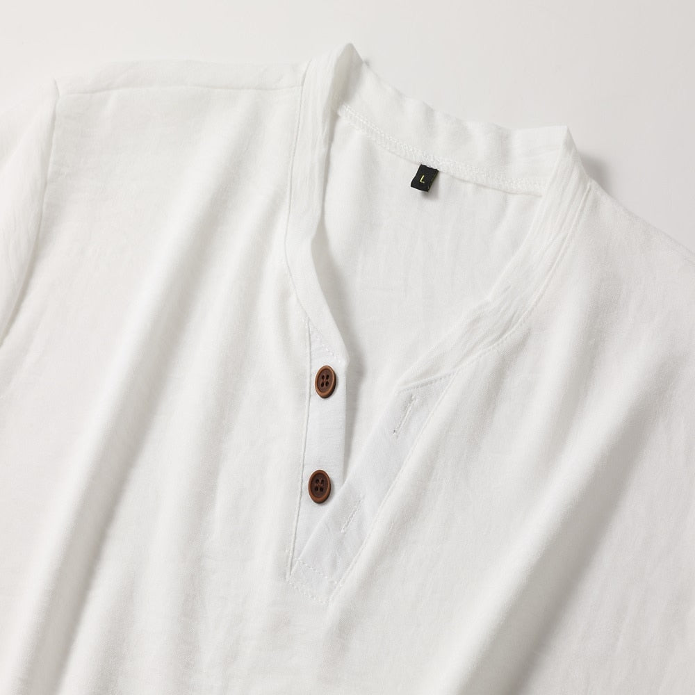White T-shirt V-neckline with two brown buttons, a stitched placket and a small size label.
