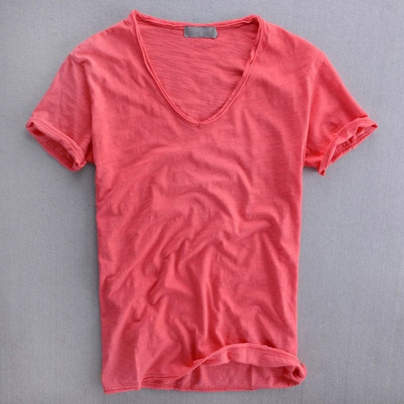 Coral pink V-neck T-shirt with rolled short sleeves and visible slub texture.
