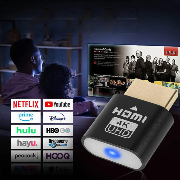 Black dongle in the foreground with a couple watching a streaming show on TV