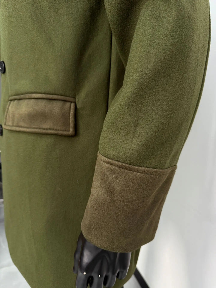 Close-up of the olive green coat's sleeve and flap pocket, showing the brushed suede-look cuff and flap texture 14