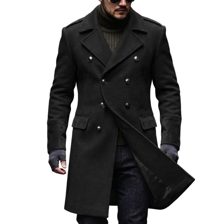 Man wearing the black double-breasted overcoat, long cut with notched lapels, shoulder epaulettes and satin lining visible at 3