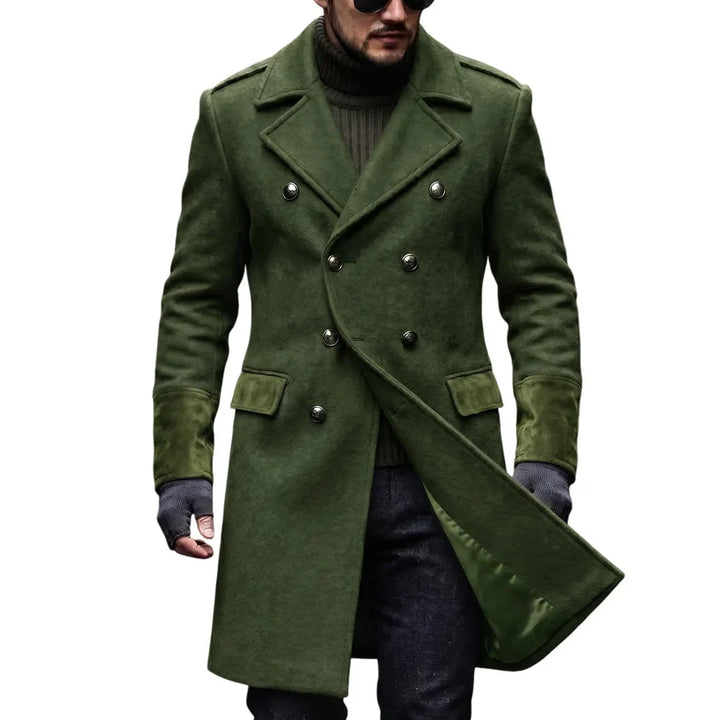 Man wearing the olive green double-breasted overcoat with metal buttons, flap pockets and suede-look cuffs over a dark 5