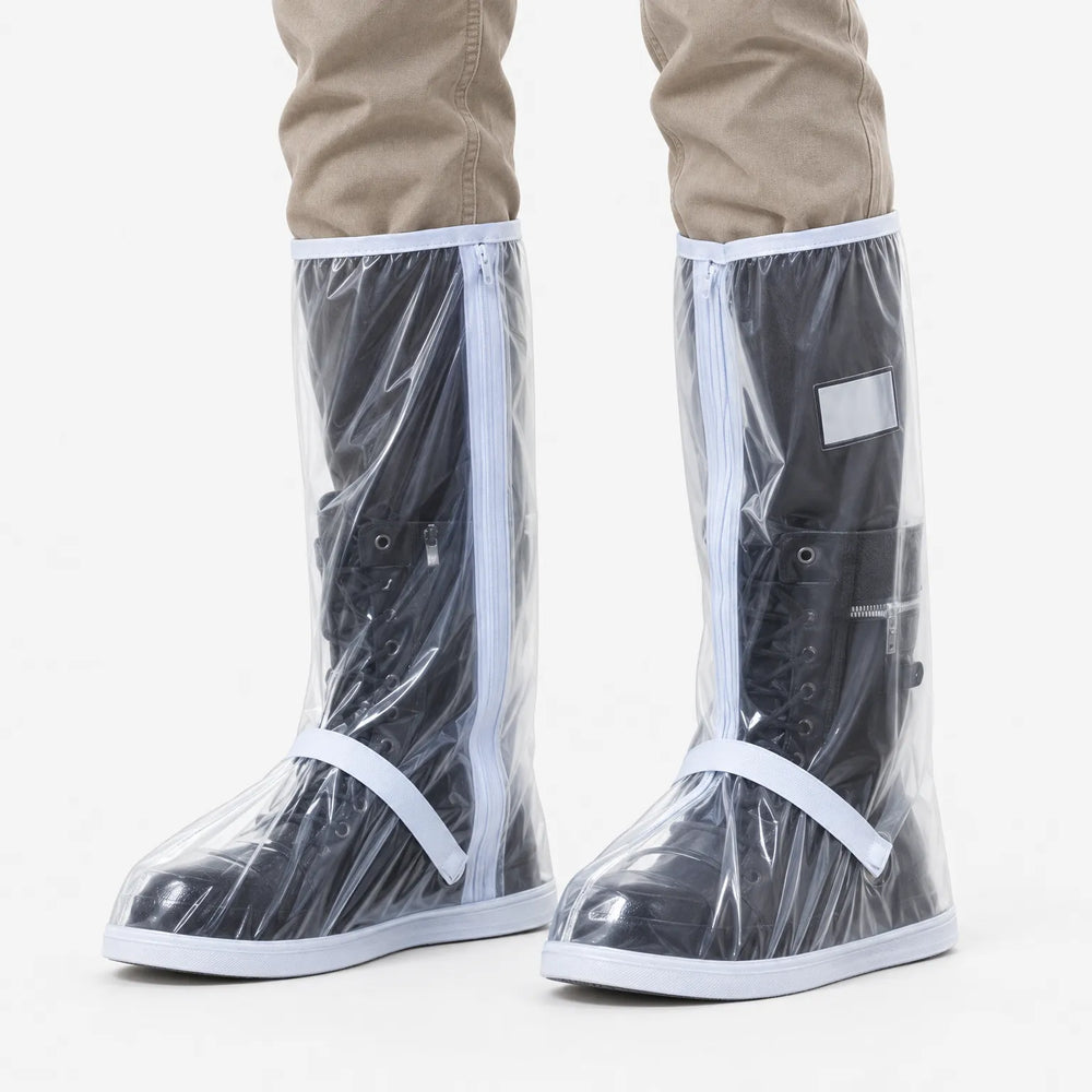 Front view of clear plastic tall shoe covers with white trim and zippers, worn over black lace-up boots with khaki pants. 2