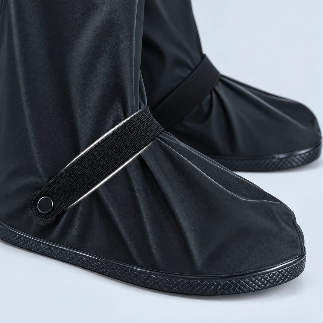 Close-up of black shoe covers at the toe and ankle, showing the elastic strap with snap button and textured rubber sole. 6