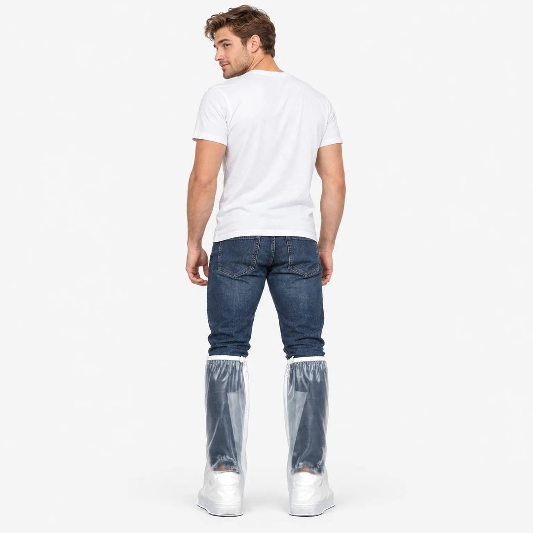 Man in a white T-shirt and jeans seen from behind, wearing clear tall overshoes with zipper and white top trim. 4