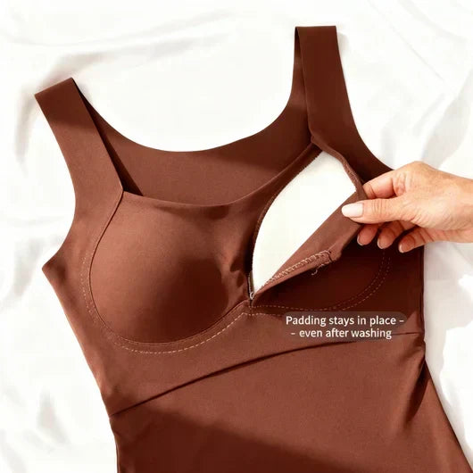Flat lay of a brown tank with its inner pocket opened by hand to show the padding 6