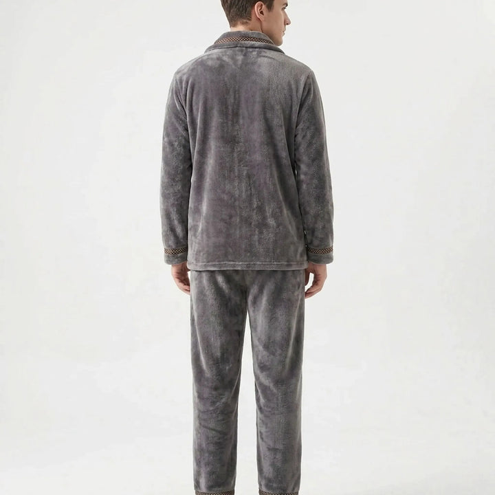 Back view of the gray fleece lounge set on a model, showing the plain back, collar trim and patterned cuffs. 3