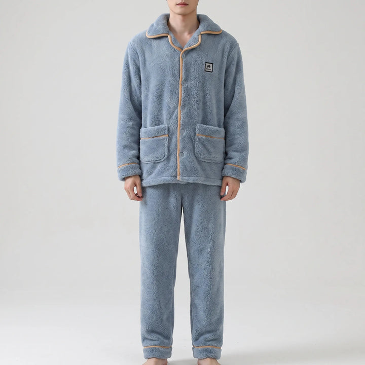 Full-length front view of the blue plush pajama set on a model, showing the buttoned top, pockets and matching pants. 2