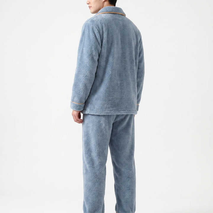 Back view of the blue fleece pajama set on a model, showing the plain back, piped cuffs and straight pants. 3