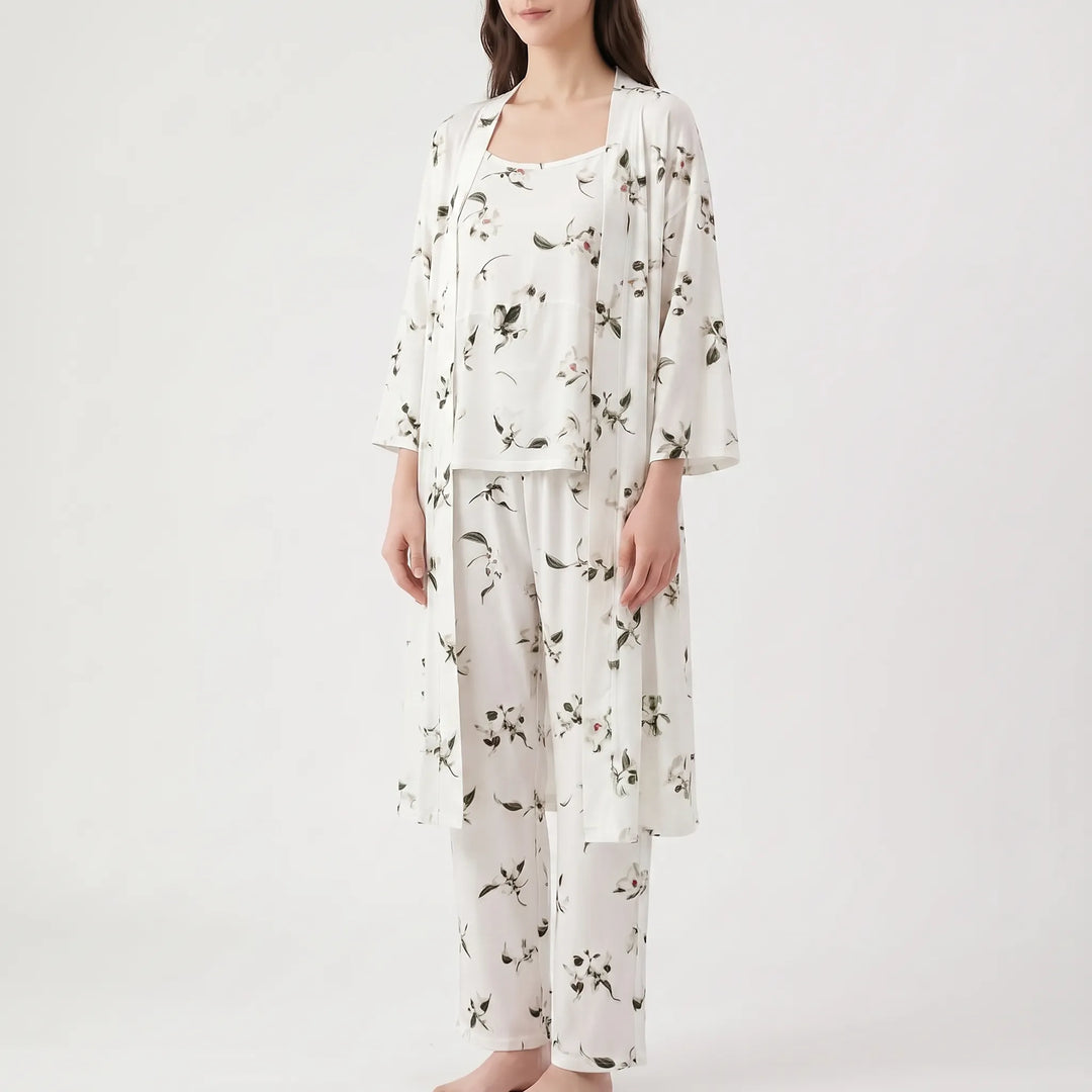 Angled view of the set in white with scattered dark green leaves and small flowers, worn by a model. 10