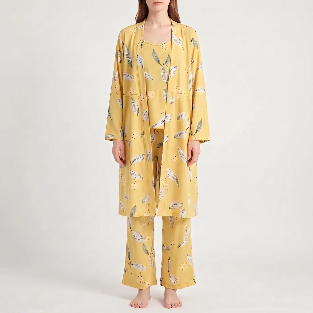 Front view of the set in yellow with white and gray-green leaves and tiny dots, worn by a model. 12