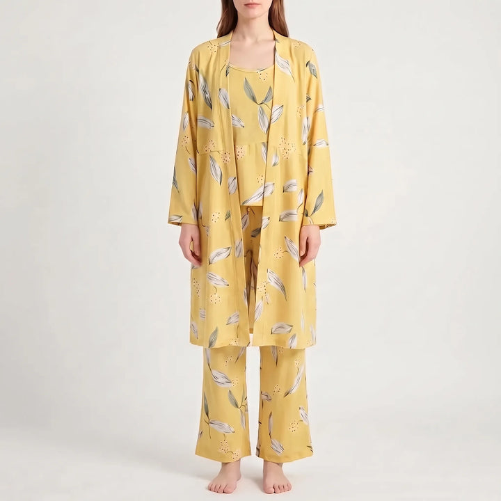 Front view of the set in yellow with white and gray-green leaves and tiny dots, worn by a model. 12