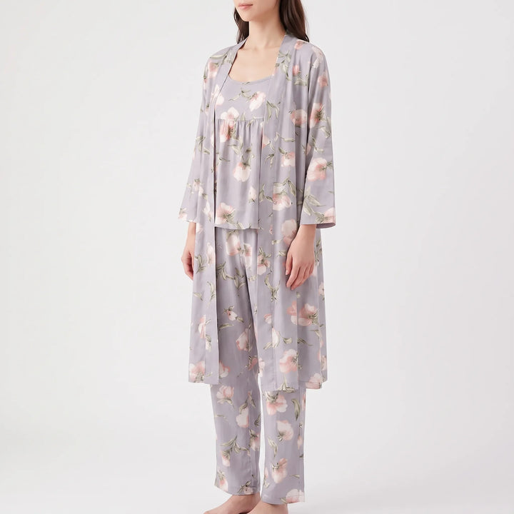 Angled front view of a model in the lavender-gray floral robe, camisole and pants, standing barefoot. 6