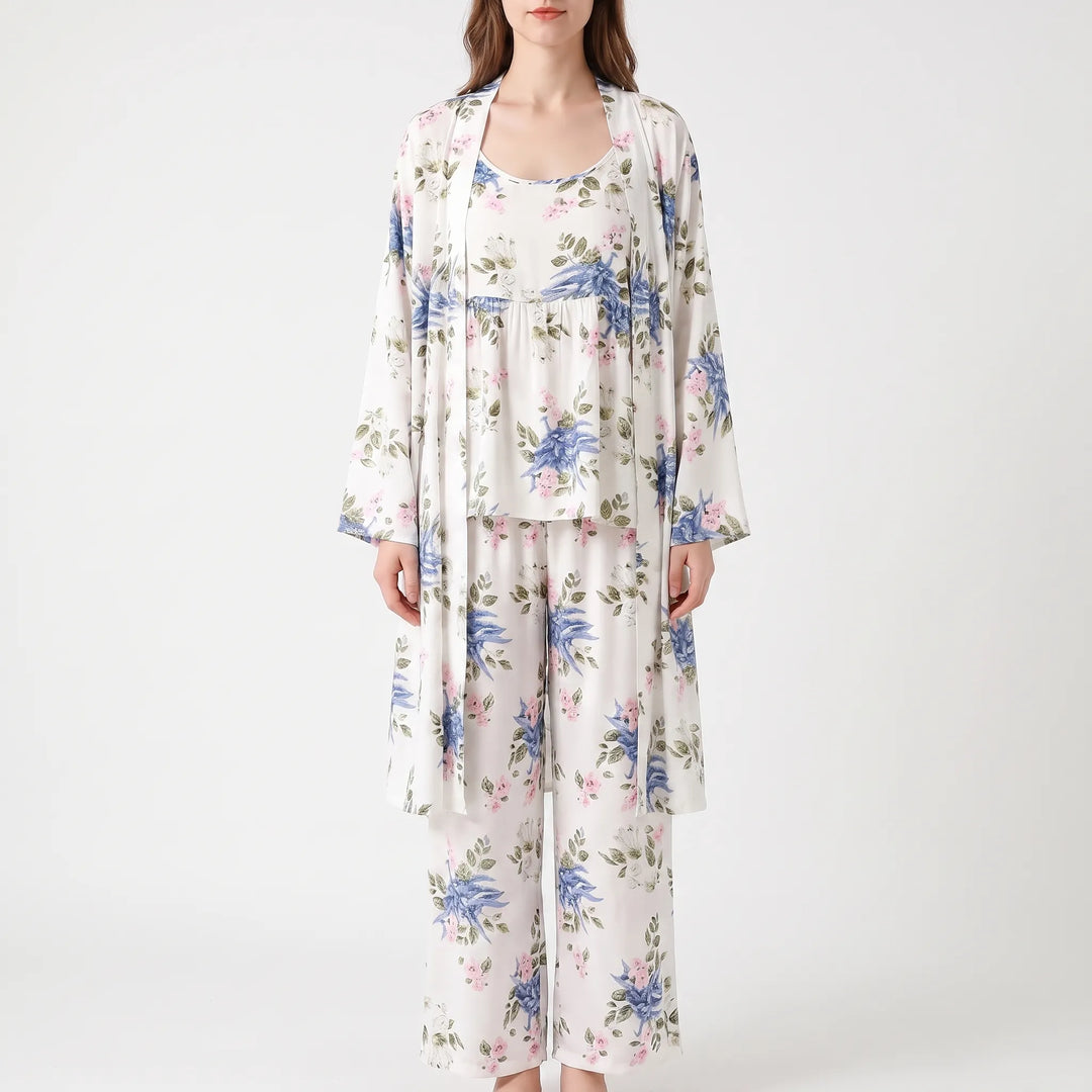 Front view of the set in a white print with blue and pink flowers and green leaves, worn by a model. 7