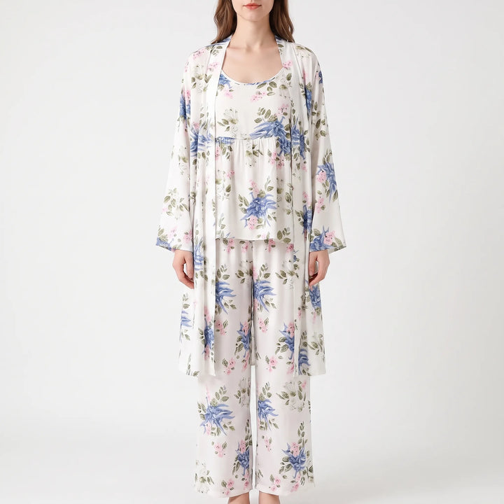 Front view of the set in a white print with blue and pink flowers and green leaves, worn by a model. 7