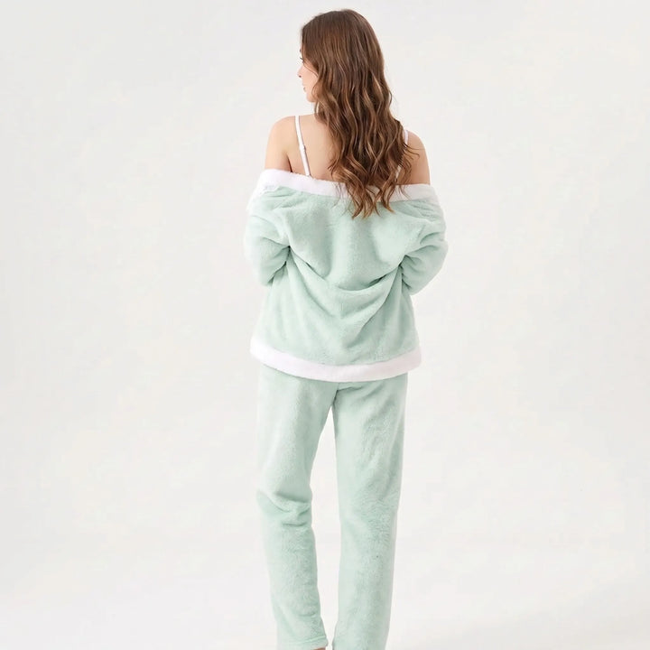 Back view of a model with long wavy hair, cardigan slipped off the shoulders over thin camisole straps and fleece pants. 3