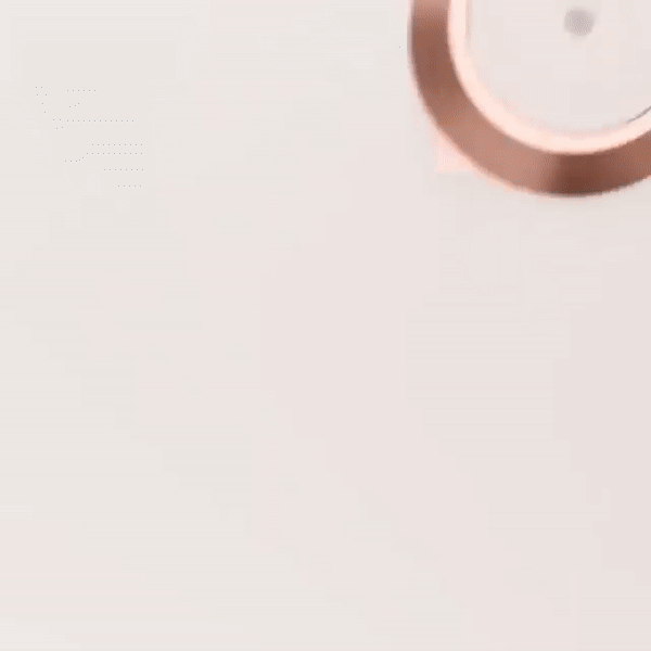 Detail of a copper-colored lamp edge on a pale background.